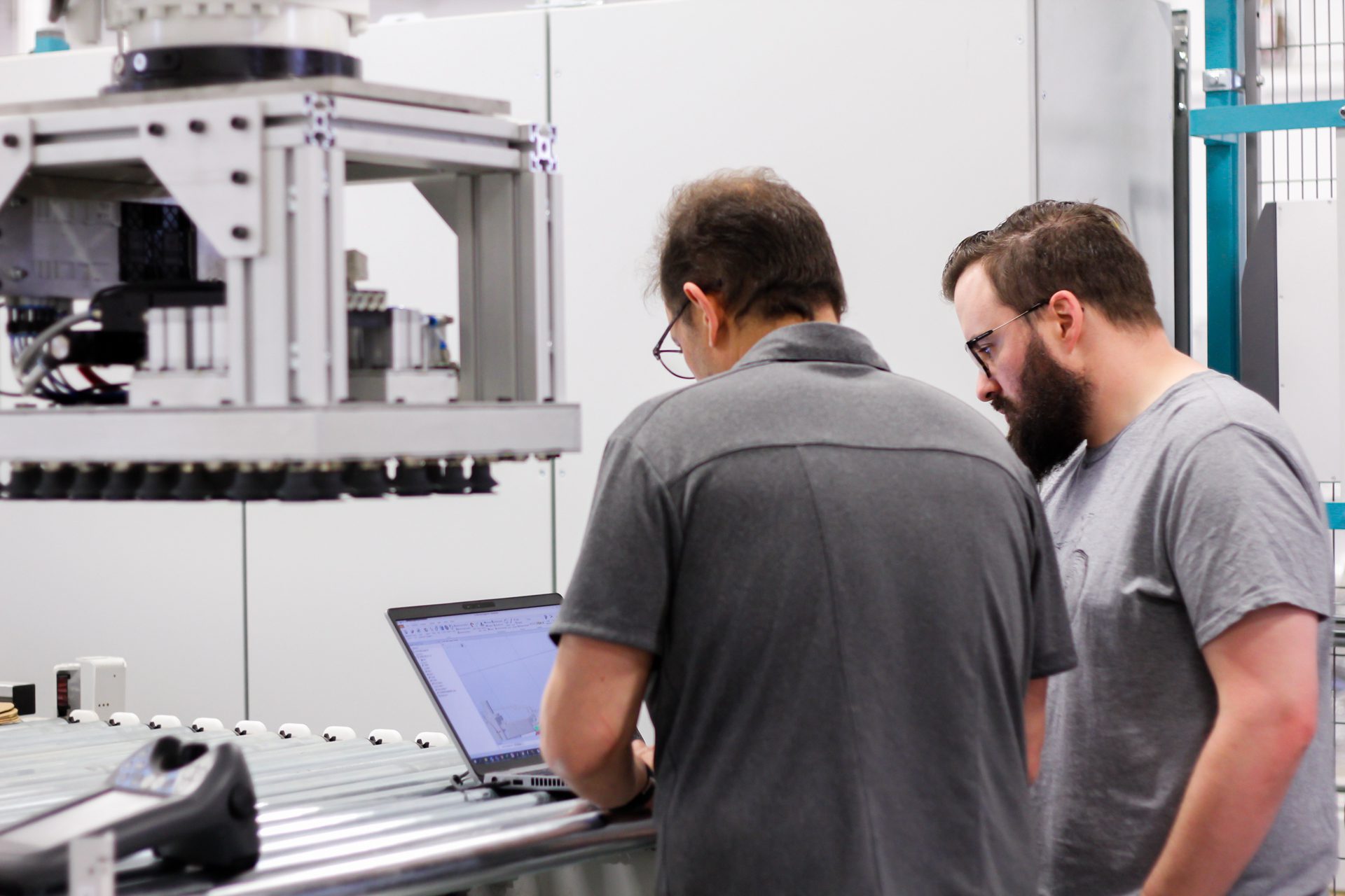 Employees in front of the NūLogik interface